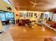 Open living area with wood floors, a coffered ceiling, and multiple access points with views to the outdoor space at 913 Red Fox Rd, Altamonte Springs, FL 32714