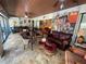 Large living room offers tile floors, fun decorations, varied seating options, and access to backyard at 913 Red Fox Rd, Altamonte Springs, FL 32714