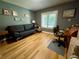 Comfortable living room featuring hardwood floors, natural light, and a sleek black futon sofa at 913 Red Fox Rd, Altamonte Springs, FL 32714