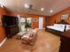 Comfortable main bedroom with a sitting area, king bed, and access to the outdoor patio at 913 Red Fox Rd, Altamonte Springs, FL 32714