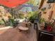 Charming outdoor area decorated with plants and comfortable seating with shade umbrella at 913 Red Fox Rd, Altamonte Springs, FL 32714