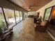 Spacious sun room with travertine tile and sliding glass doors to landscaped outdoor area at 913 Red Fox Rd, Altamonte Springs, FL 32714