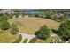 Expansive community green space with walking paths, amenities, and a serene lake view at 9432 Komika Ln, Winter Garden, FL 34787