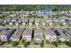 Aerial view of a vibrant residential community with a lake and green spaces at 9432 Komika Ln, Winter Garden, FL 34787