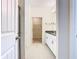 Hallway view of an immaculate bathroom, leading to a walk-in closet with wire shelving at 9432 Komika Ln, Winter Garden, FL 34787