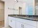 This bathroom view shows the double vanity and closet at 9432 Komika Ln, Winter Garden, FL 34787