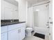 This bathroom features a single vanity with granite countertop and a shower with curtain at 9432 Komika Ln, Winter Garden, FL 34787