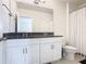 Bathroom featuring a double vanity with granite countertops and a shower with curtain at 9432 Komika Ln, Winter Garden, FL 34787
