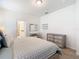 Bedroom features a queen bed, small vanity, and dresser at 9432 Komika Ln, Winter Garden, FL 34787