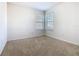 This bedroom features two windows, neutral walls, and carpet flooring at 9432 Komika Ln, Winter Garden, FL 34787