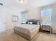 Bedroom featuring a queen bed with two nightstands and decorative window treatments at 9432 Komika Ln, Winter Garden, FL 34787