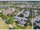 Aerial view of the clubhouse, parking lot, and lake showcasing community amenities and lush landscaping at 9432 Komika Ln, Winter Garden, FL 34787