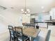 Dining area leading to a kitchen with modern appliances, and staircase access to the upper floor at 9432 Komika Ln, Winter Garden, FL 34787