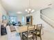 Open-concept dining room with hardwood floors connecting to the living room and staircase at 9432 Komika Ln, Winter Garden, FL 34787