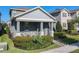 Two-story home featuring a covered porch, stone accents, and a well-manicured lawn at 9432 Komika Ln, Winter Garden, FL 34787