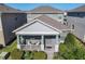 Charming single-Gathering home featuring a cozy front porch with stylish outdoor seating and landscaped front yard at 9432 Komika Ln, Winter Garden, FL 34787