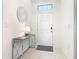 Bright entryway with a decorative mirror, a console table, and a tiled floor at 9432 Komika Ln, Winter Garden, FL 34787