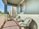 Inviting porch featuring wicker chairs, a small table, and views of the quiet neighborhood at 9432 Komika Ln, Winter Garden, FL 34787