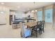 Open concept kitchen and dining area featuring an island and stainless steel appliances at 9432 Komika Ln, Winter Garden, FL 34787