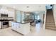 Open-concept kitchen with stainless steel appliances, granite countertops, and an island with seating at 9432 Komika Ln, Winter Garden, FL 34787