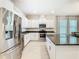 Modern kitchen featuring stainless steel appliances and a large island at 9432 Komika Ln, Winter Garden, FL 34787