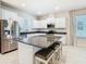 Modern kitchen featuring stainless steel appliances, a large island, and ample cabinet space at 9432 Komika Ln, Winter Garden, FL 34787
