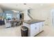 Open-concept kitchen with granite island, white cabinets, and eat-in dining area at 9432 Komika Ln, Winter Garden, FL 34787