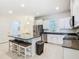 Spacious kitchen featuring granite counters, island seating, and stainless steel appliances at 9432 Komika Ln, Winter Garden, FL 34787