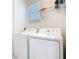 Well-equipped laundry room with modern, white washer and dryer units at 9432 Komika Ln, Winter Garden, FL 34787