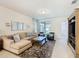 Inviting living room with comfortable seating, media center, and natural light at 9432 Komika Ln, Winter Garden, FL 34787