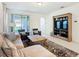 Cozy living room with comfortable seating, built-in shelving, and access to the patio at 9432 Komika Ln, Winter Garden, FL 34787