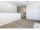The loft has carpet, neutral walls, and access to the bedrooms and bathrooms at 9432 Komika Ln, Winter Garden, FL 34787