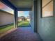 Covered patio with brick pavers and a view of the manicured lawn and neighboring houses at 9432 Komika Ln, Winter Garden, FL 34787