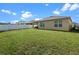 Green backyard with lawn, fence, and covered patio at 1059 Cypress Fox Blvd, Davenport, FL 33897