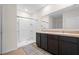 Bathroom with double sink vanity, large mirror, and a walk-in shower at 1059 Cypress Fox Blvd, Davenport, FL 33897