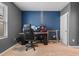 Functional bedroom space with a desk setup, ideal for work or gaming, and a cozy carpet at 1059 Cypress Fox Blvd, Davenport, FL 33897