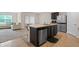 An open concept kitchen features stainless steel appliances and a large island with a sink at 1059 Cypress Fox Blvd, Davenport, FL 33897