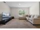 This living room is carpeted and has a window and couch at 1059 Cypress Fox Blvd, Davenport, FL 33897