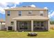 Back of house featuring a covered, screened patio and lawn at 1118 Franklin Tree Ln, Sanford, FL 32771