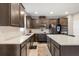 Modern kitchen featuring sleek countertops, stainless steel appliances, and custom dark wood cabinetry at 1118 Franklin Tree Ln, Sanford, FL 32771