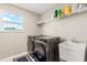 Functional laundry room equipped with modern washer and dryer units and ample storage space at 1118 Franklin Tree Ln, Sanford, FL 32771