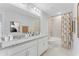 Bright bathroom with double sinks, granite countertops, and a stylish shower/tub combo, perfect for everyday use at 1211 Normandy Dr, Haines City, FL 33844