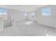 Upstairs bonus room with soft carpet and bright windows, perfect for relaxing at 1211 Normandy Dr, Haines City, FL 33844