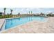 Sparkling community pool surrounded by lounge chairs and lush landscaping, perfect for relaxation and recreation at 1211 Normandy Dr, Haines City, FL 33844