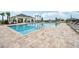Community pool featuring a spacious deck, comfortable seating, and a shade structure, ideal for relaxation and community gathering at 1211 Normandy Dr, Haines City, FL 33844