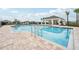 Resort-style community pool with comfortable lounge chairs, providing a perfect oasis for relaxation and recreation at 1211 Normandy Dr, Haines City, FL 33844