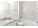 Bright bathroom featuring a granite-topped sink and shower with marble-patterned tile at 13 Oak Trail Pl, Ocala, FL 34472