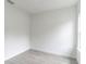 Spare bedroom featuring light gray vinyl flooring, white walls, and a window at 13 Oak Trail Pl, Ocala, FL 34472