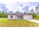 Charming single-story home featuring a two-car garage and a well-maintained lawn at 13 Oak Trail Pl, Ocala, FL 34472