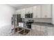 Granite countertops highlight the stainless steel appliances and white cabinets in this kitchen at 13 Oak Trail Pl, Ocala, FL 34472